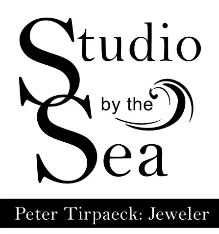 A black and white image of the logo for studio by the sea.