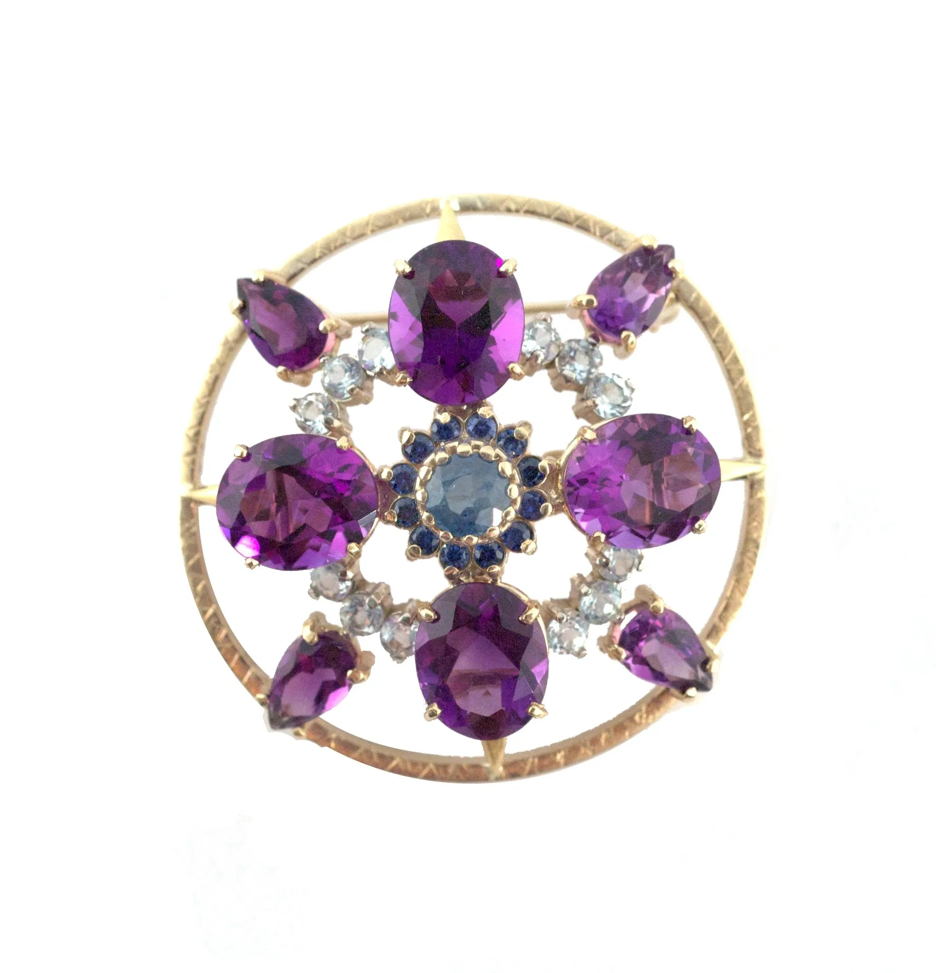 A gold circle with purple and blue stones.
