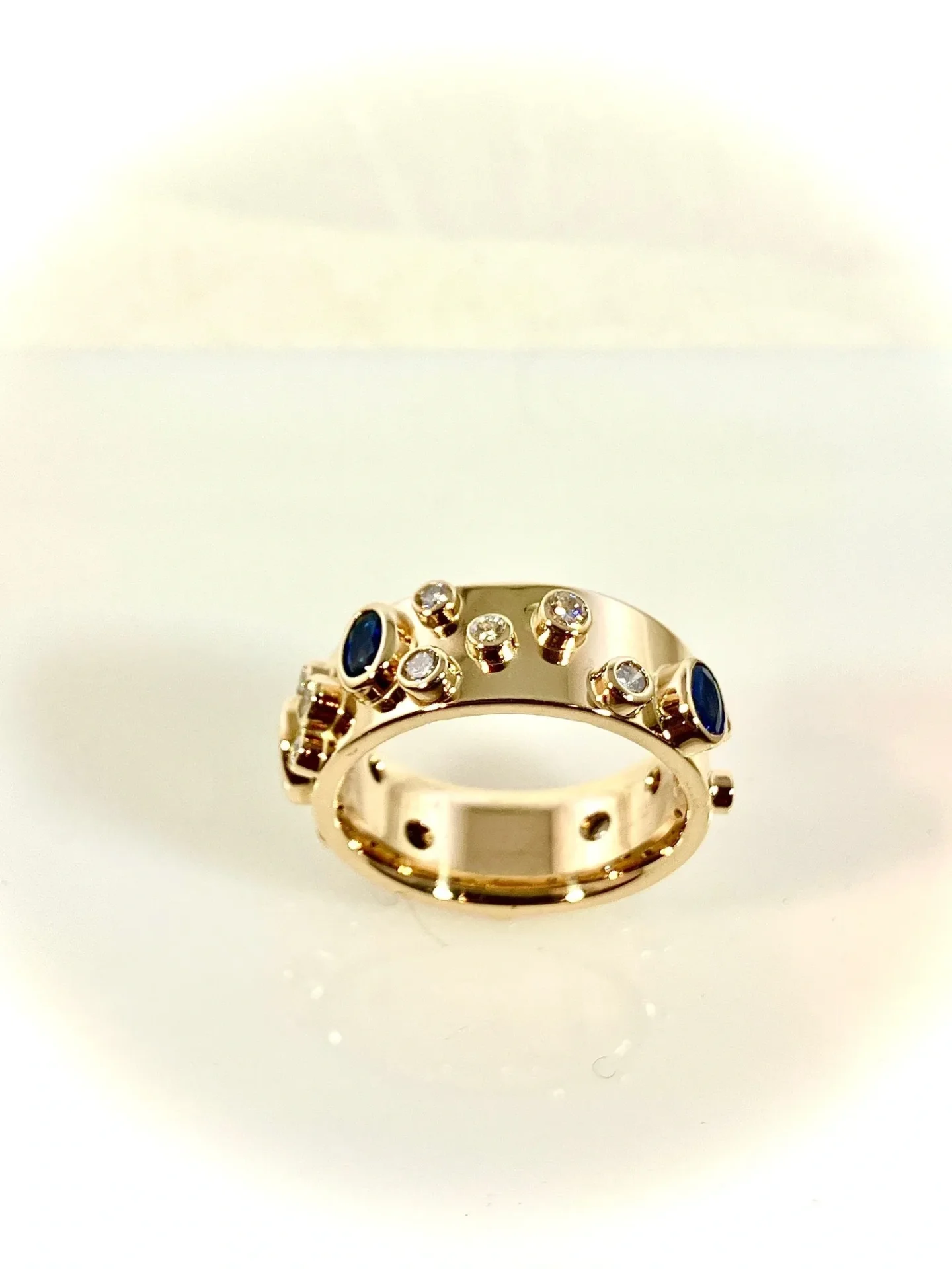 A gold ring with some blue and white stones