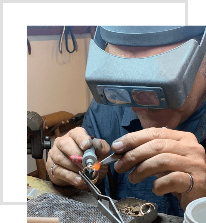 A man working on an object with a welding tool.