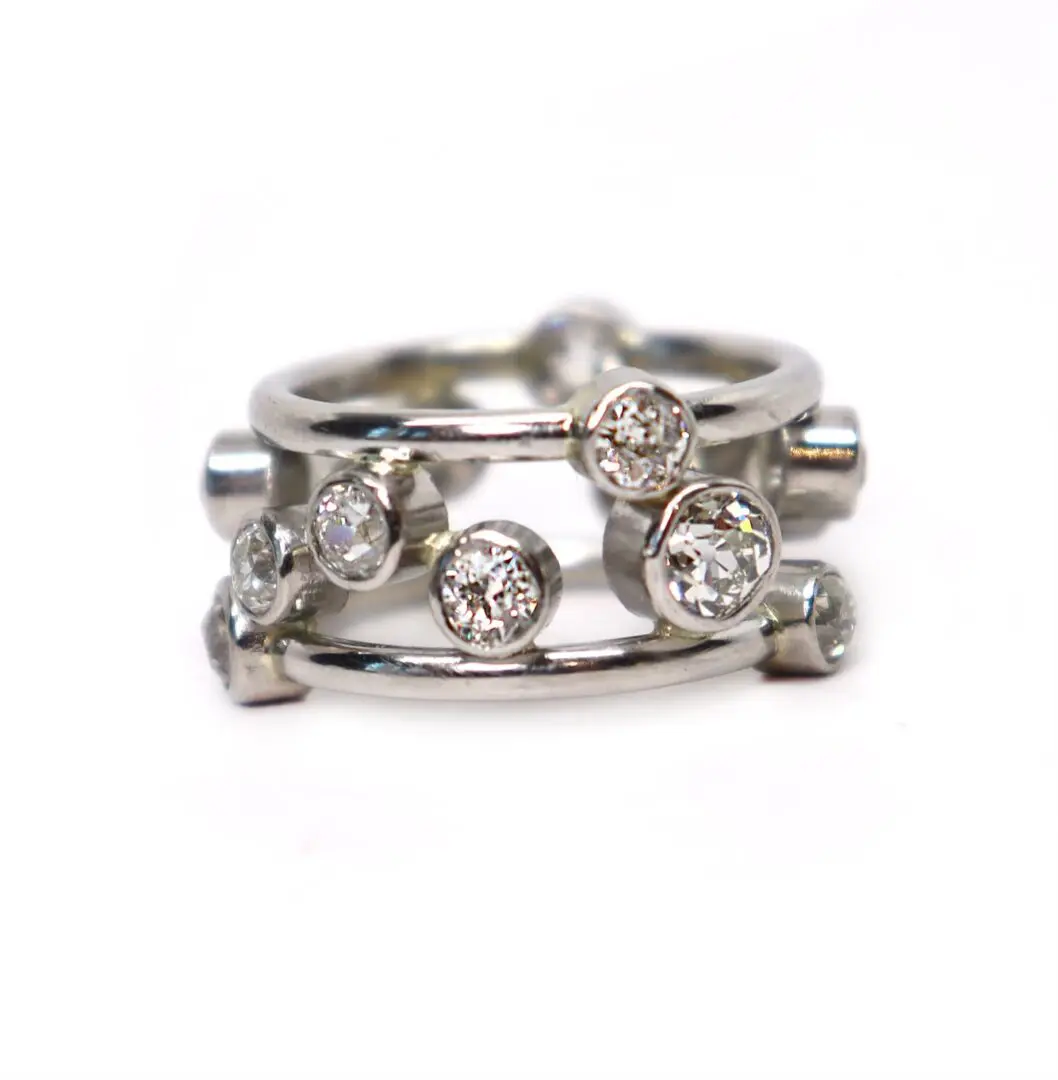 A silver ring with some small diamonds on it