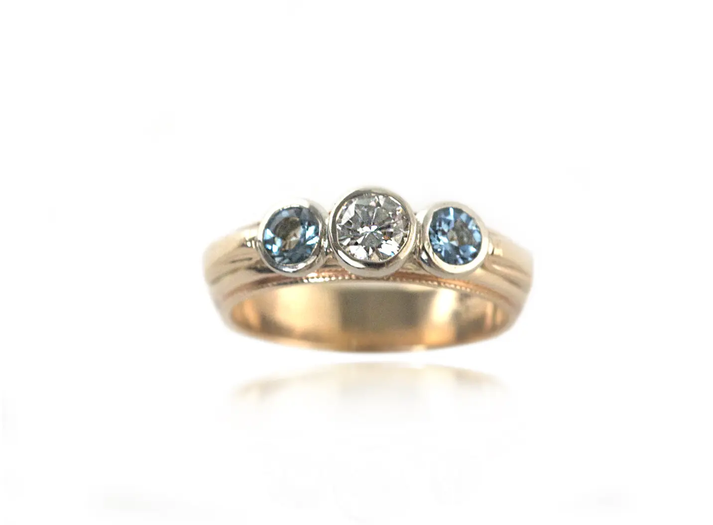 A gold ring with three stones on it