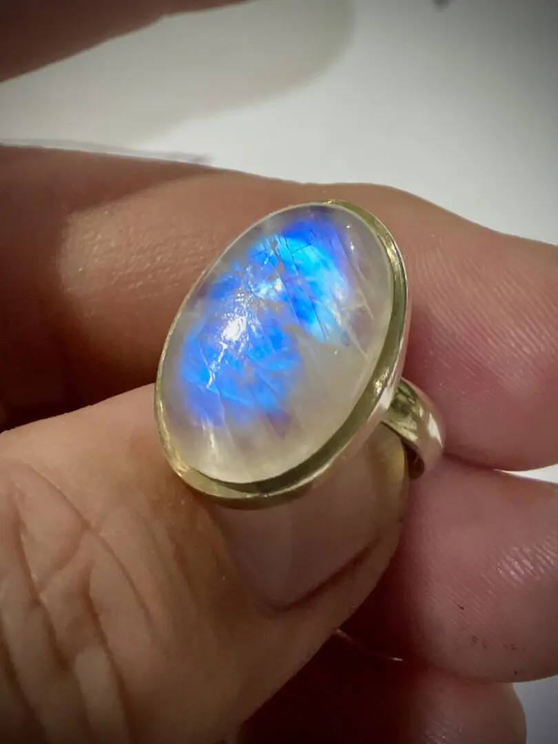 A person holding onto a ring with a blue light