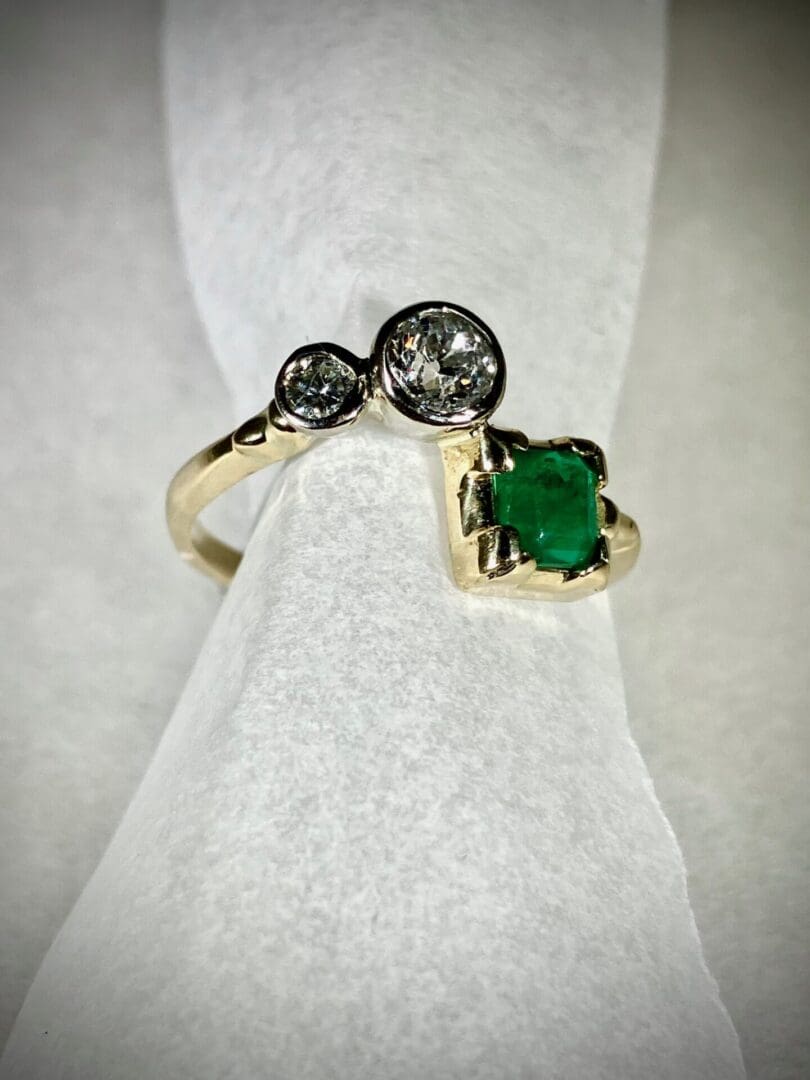 A gold ring with a green stone on it