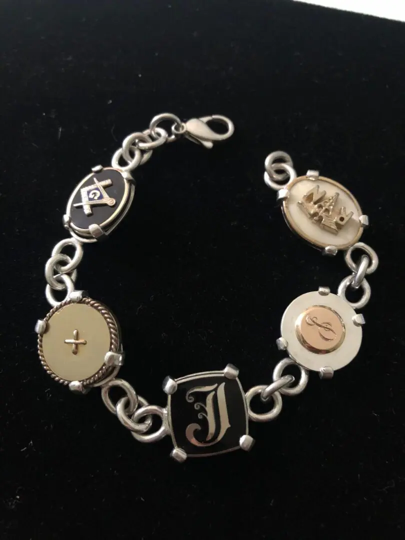 A bracelet with different types of initials on it.