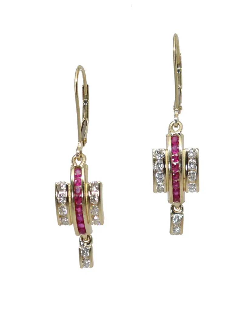 A pair of earrings with red and clear stones.