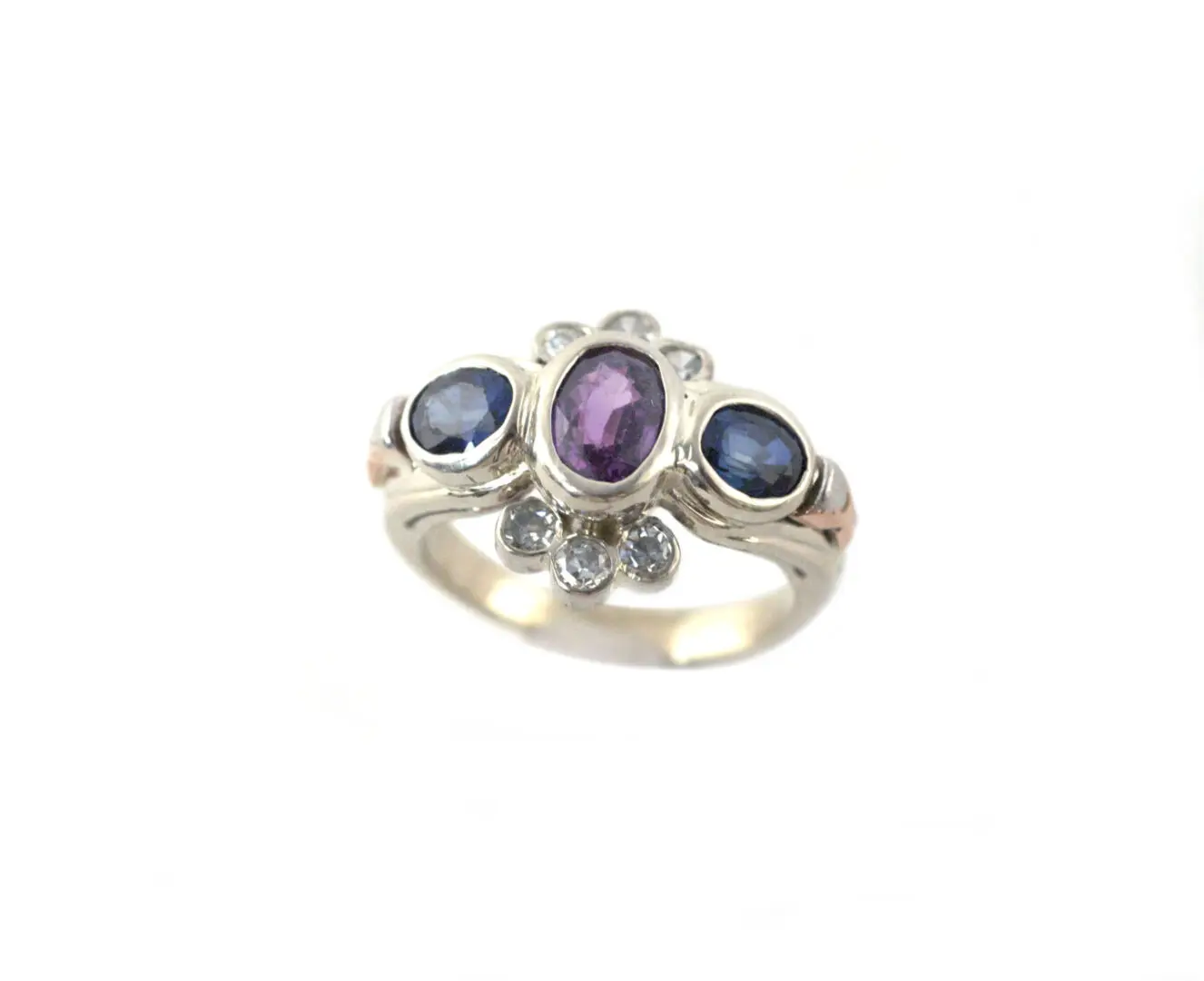 A silver ring with three stones on it.