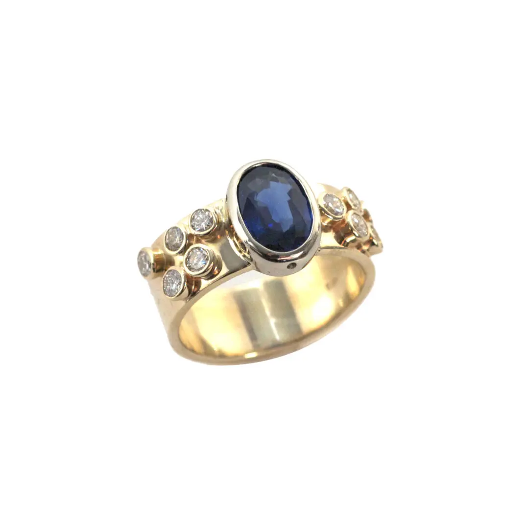 A gold ring with a blue stone and some white stones